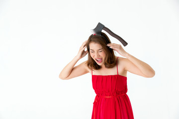 Woman in red dress with fake axe on head and acting look like hurting on white background. Concept for funny playing costume in halloween festival