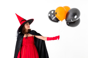 Studio shot Asian woman in red costume witch  hand holding a orange and black balloon isolated on...