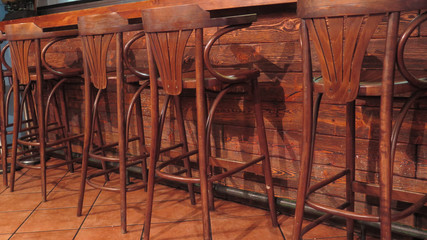 Row of vacant wooden bar stools