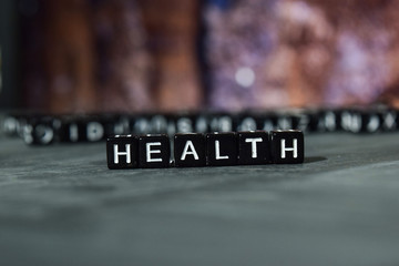 Health on wooden blocks. Cross processed image with bokeh background