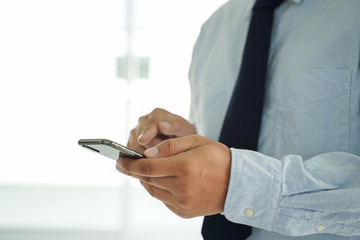 Business man hold the smartphone on the street  and copy space.