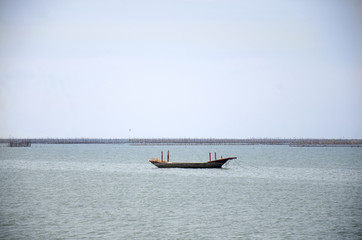 Fishing boat and ship floating in the sea for waiting fishing in night time in Chonburi, Thailand