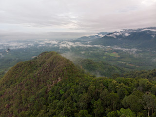 Aerial view of mountain with cloudy background.