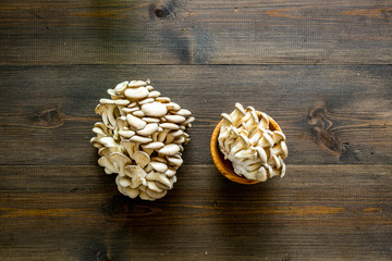 Oyster mushroom. Fresh raw veshenka on dark wooden background top view space for text