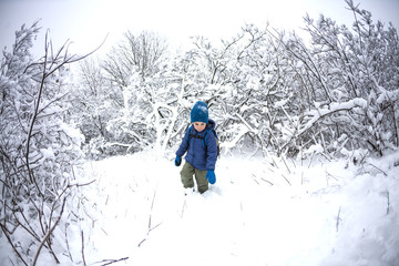 Fototapeta na wymiar A child runs through the snow.