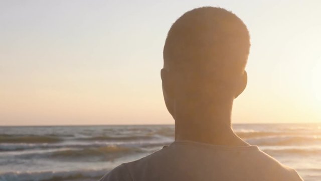 Pensive young african migrant looking the horizon,thinking home-steady cam