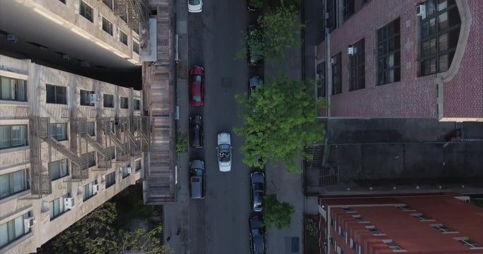 Look Down Shot Of A Convertible Mercedes Benz In Harlem With Buildings