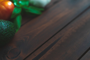 Assorted farm to table fresh vegetables on a dark brown wooden table