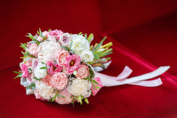 Wedding bridal bouquet on red background, close-up