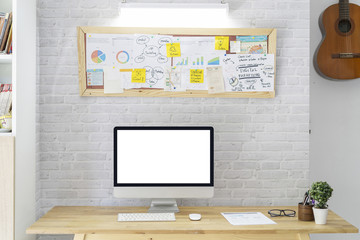 Stylish workspace with computer on home office board meeting, On wooden table with white brick wall
