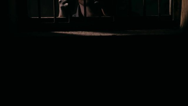 sad Young black criminal alone in the jail. Law,prison, punishment