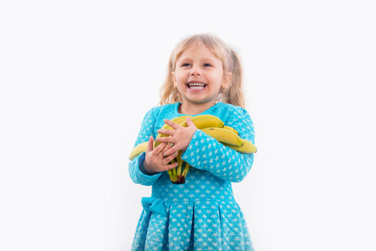 Child, little girl posing positively with bananas.