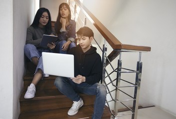 Group Students Smile and have fun and using tablet It also helps to share ideas in the work and project. And also review the book before the exam