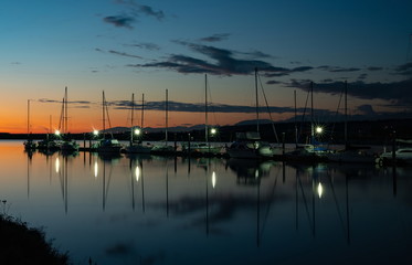 Fototapeta na wymiar Beautiful sunset with sailboat in the crecent beach, Surrey, Canada