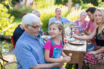  Family picnic closeup on a grandfather and his granddaughter