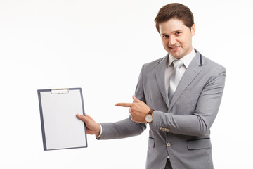 Young businessman showing blank clipboard, isolated on white background. Success in business, job and education concept shot