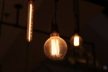 A electric lamp lighting . modern and vintage style , interior ceiling hanging light bulb decorate at room