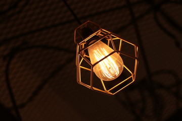 A electric lamp lighting . modern and vintage style , interior ceiling hanging light bulb decorate at room