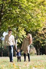 Fototapeta premium family with a baby in autumn park