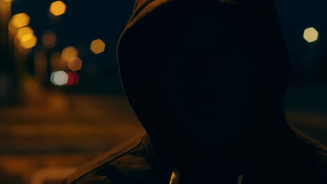 Mysterious man alone with hood in the city at night.crime, fear - No face