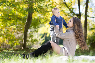 Fototapeta premium mother with baby in autumn park