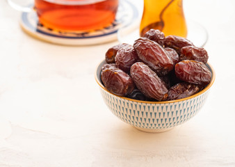 Fresh Medjool Dates in a bowl. Ramadan kareem. White background. Turkish style. Copy space.
