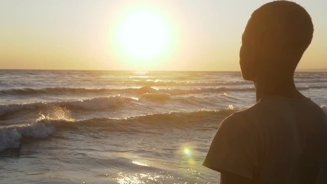 Migration,refugee,Homeland. Sad black man looking the sea at sunset