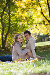 Naklejka na ściany i meble Young couple in autumn park