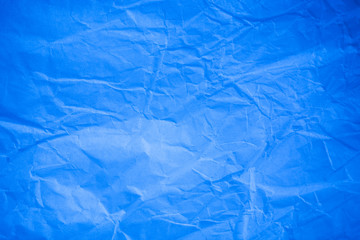 Obraz premium Crumpled blue paper background.