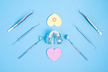 Dental tools use for dentist on the blue background, flat lay, top view.