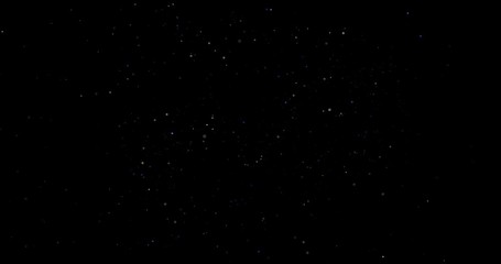 Flying dust particles on a black background