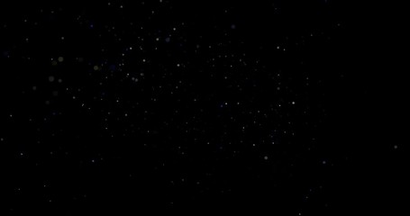 Flying dust particles on a black background