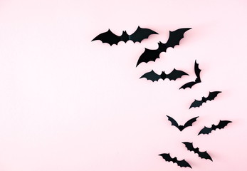 Halloween decorations concept. Halloween bats on pastel pink background. Flat lay, top view, copy space 