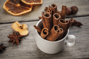 Cinnamon sticks on wooden background.