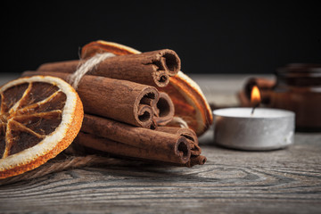 Cinnamon sticks on wooden background.