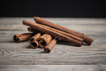 Cinnamon sticks on wooden background.