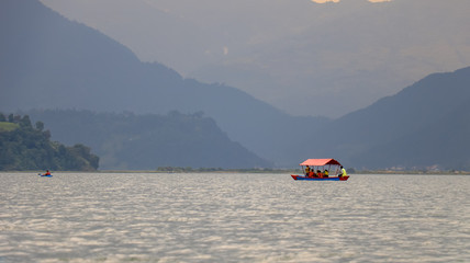 People sailing in a boat in Phewa Lake of Pokhara, Nepal
