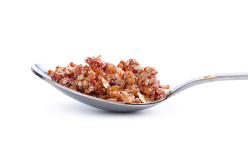 Photo of Full spoon of granola isolated on white background