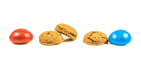 Row of colorful Pepernoten traditional dutch treats on white background