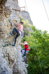 Photo of sports woman climbing mountain