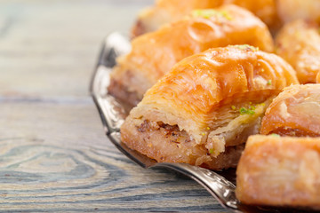 Delicious baklava dessert in oriental bronze setting close up