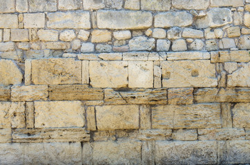 Fragment of the stone wall of the ancient city. Russia, the Republic of Crimea, the city of Sevastopol. 11.06.2018: The ruins of the ancient and medieval city of Chersonese Tauride