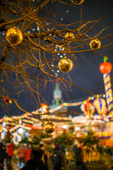 Picture of tree with golden balls on background of building