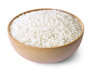 Raw, parboiled rice in a wooden bowl. Rice dish, isolated on white background, diet or healthy eating scene.