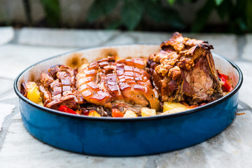 Preparing and cooking pork roast in traditional metal pot Peka.