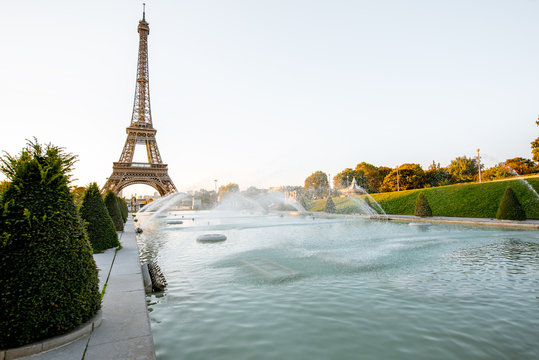 Landscape view of the Eiffel tower with fountains during the sunrise in Paris