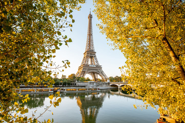 Landsacpe view of Eiffel tower during the sunrise with beautiful yellow trees in autumn in Paris