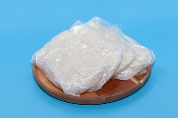 close up of sticky rice in plastic bag in Thai style on blue background