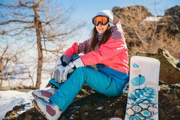 a young woman in a ski mask rests on the mountain