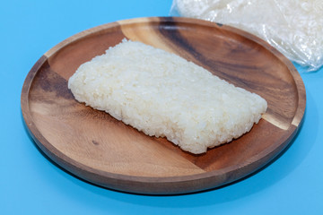 Fototapeta na wymiar close up of sticky rice in plastic bag in Thai style on blue background